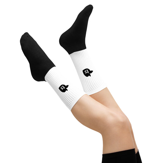 White socks with black logo worn by a person on a white background