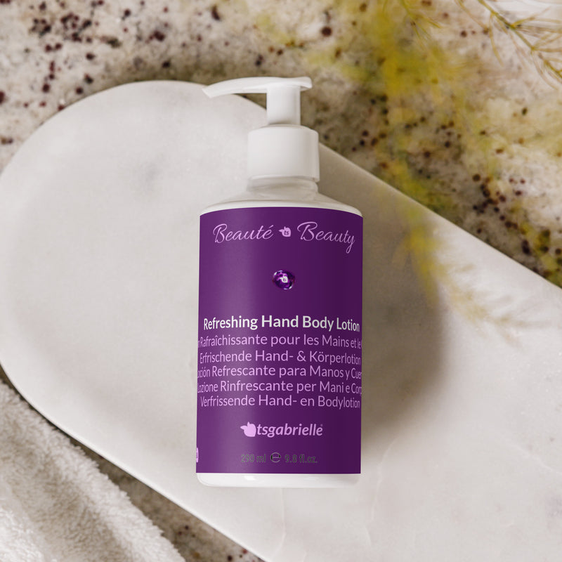 Purple bottle of tsgabrielle refreshing hand body lotion on a textured surface